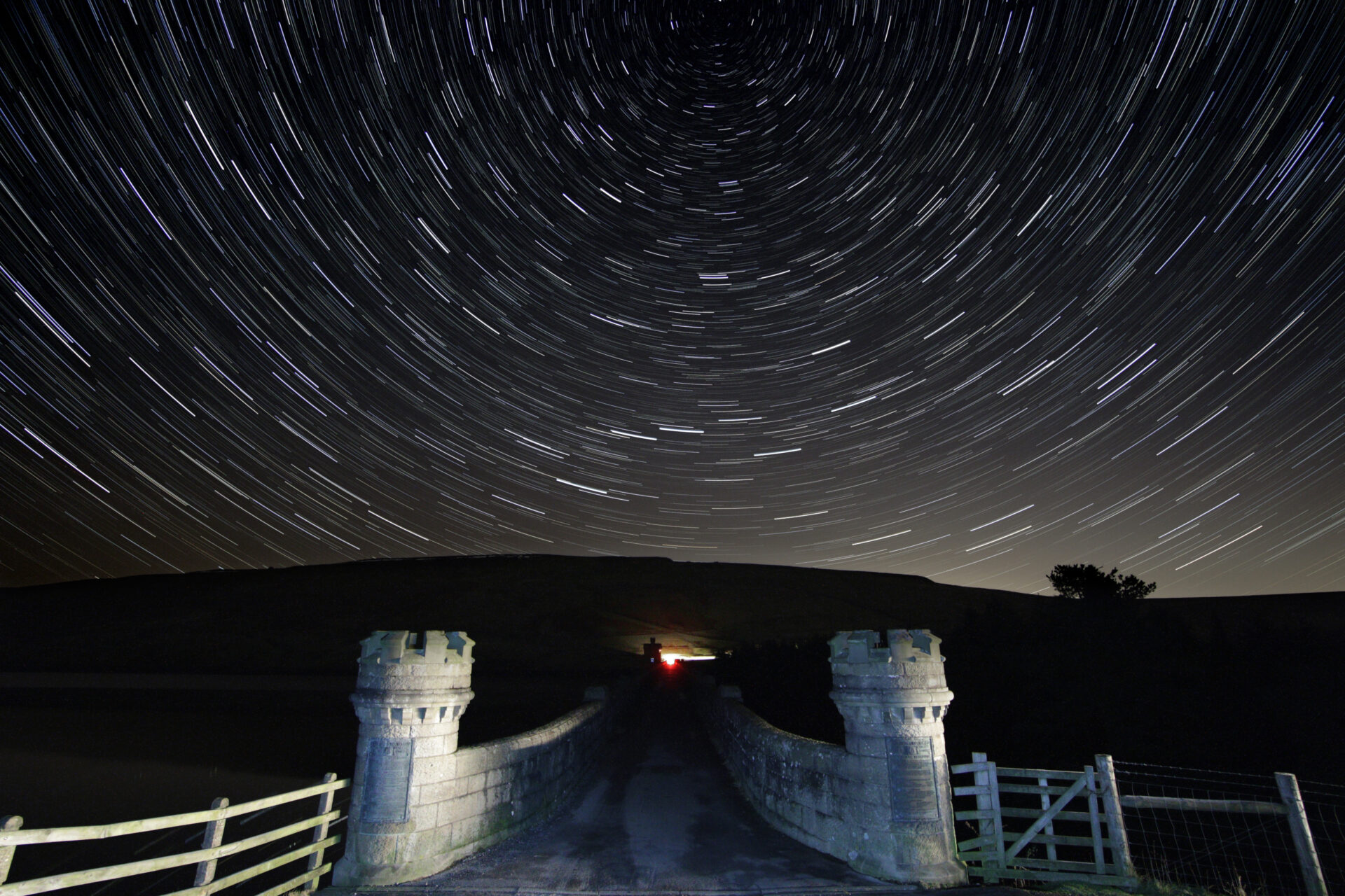 View over stone bridge with turrets, into dark, starry sky