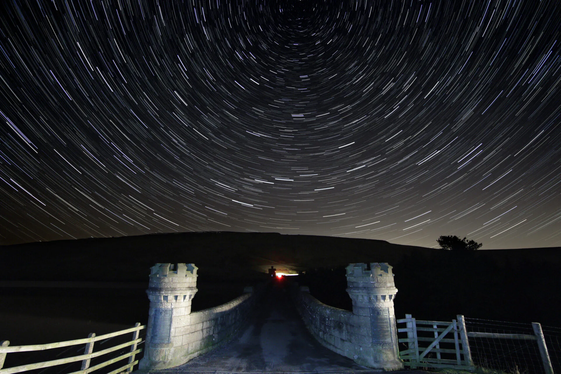 View over stone bridge with turrets, into dark, starry sky